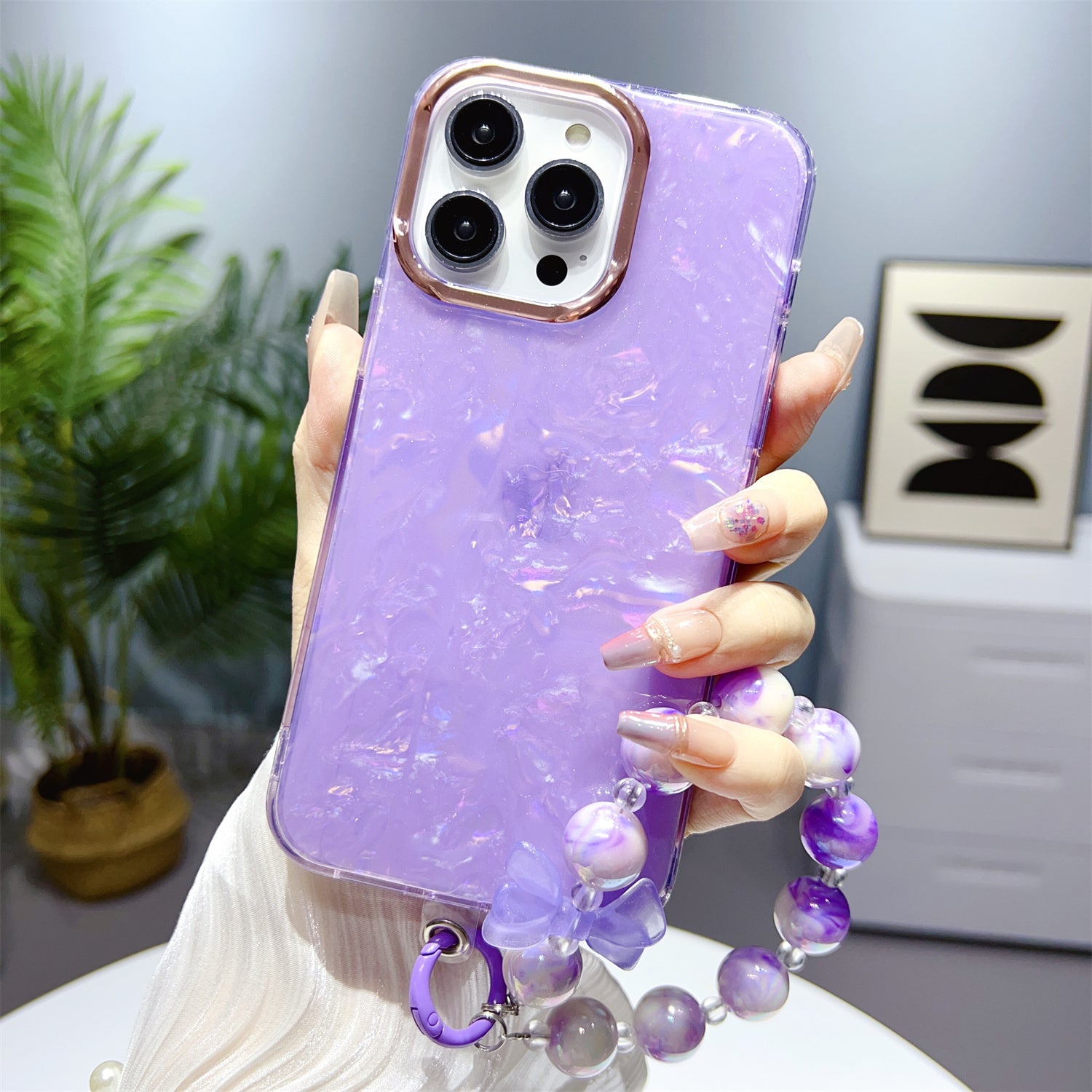 Uniqkart for iPhone 13 Pro Max 6.7 inch TPU+PC Phone Cover IMD Shell Pattern Anti-drop Case with Pearl Hand Chain - Light Purple Uniqkart for iPhone 13 Pro Max 6.7 inch TPU+PC Phone Cover IMD Shell Pattern Anti-drop Case with Pearl Hand Chain - Light Purple